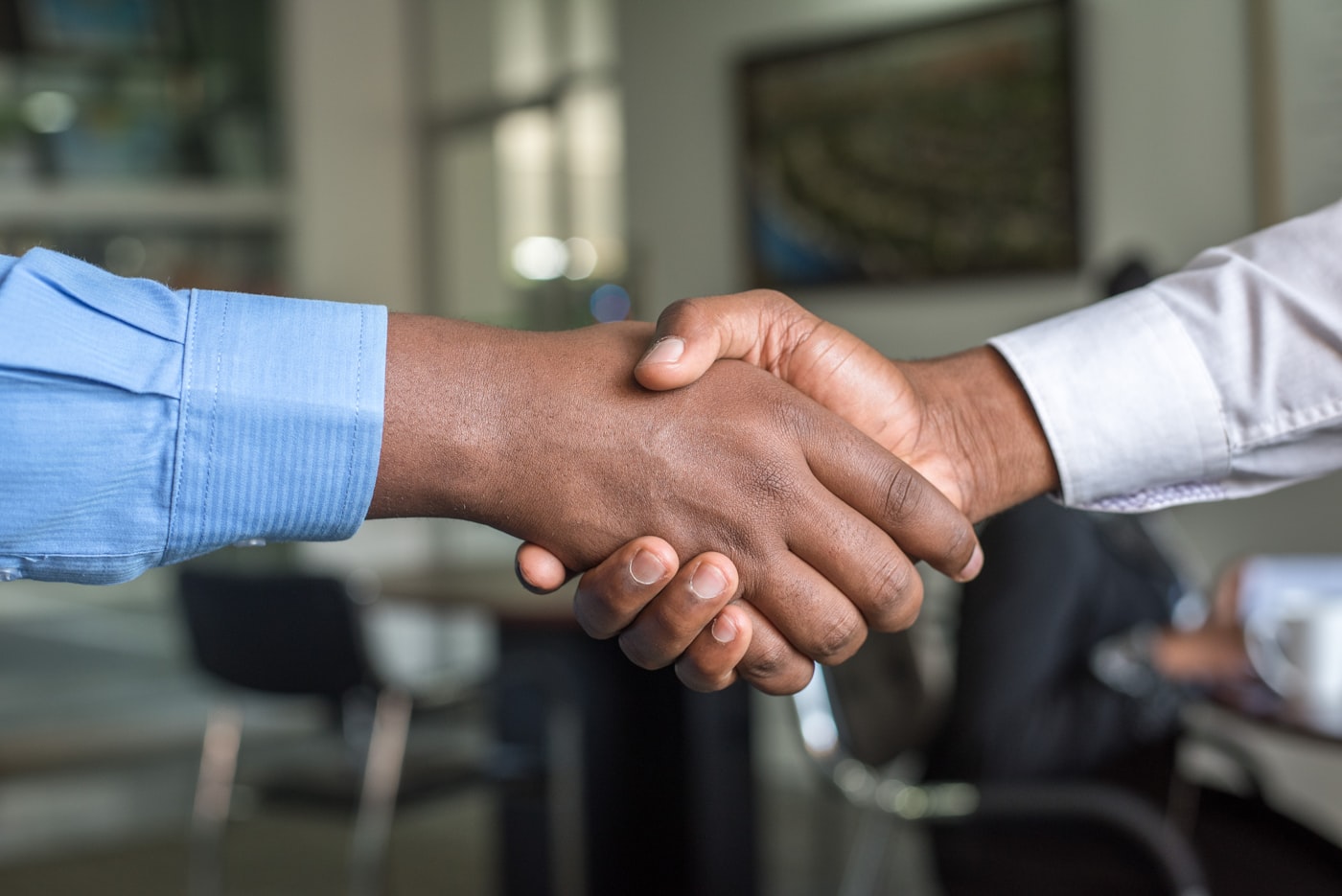 Advisor shaking hands with a client after a policy review